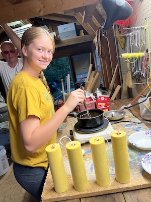 Young beekeeper processing hive products
